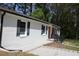 A well-maintained home showcasing a red front door and a freshly painted white brick exterior at 3811 Crosby Nw Dr, Atlanta, GA 30331