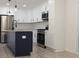 Modern kitchen boasting a center island, white cabinets, stainless steel appliances, and hardwood floors at 3811 Crosby Nw Dr, Atlanta, GA 30331