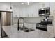 Beautiful kitchen featuring stainless steel appliances, granite countertops, and white cabinets at 3811 Crosby Nw Dr, Atlanta, GA 30331
