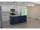 Open-concept kitchen featuring a dark blue island, granite countertops, and stainless steel appliances at 3811 Crosby Nw Dr, Atlanta, GA 30331
