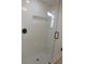 Modern shower featuring glass door, white subway tile, and matte black hardware at 3811 Crosby Nw Dr, Atlanta, GA 30331
