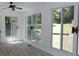 Spacious sunroom with multiple windows offering backyard views and a ceiling fan at 3811 Crosby Nw Dr, Atlanta, GA 30331
