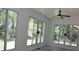 Sunroom featuring large windows and modern ceiling fan with views of the backyard at 3811 Crosby Nw Dr, Atlanta, GA 30331