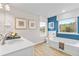 Bathroom featuring a bathtub and large window at 417 Brooch Way, Stockbridge, GA 30281