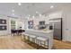 Modern kitchen features stainless steel appliances, quartz countertops, and ample seating at 417 Brooch Way, Stockbridge, GA 30281