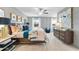 Spacious main bedroom with large bed, elegant furnishings, decorative art, and plenty of natural light at 417 Brooch Way, Stockbridge, GA 30281