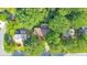 An aerial view shows the house surrounded by dense trees and established landscaping in a suburban neighborhood at 951 Woodmont Dr, Marietta, GA 30062