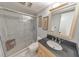 Modern bathroom featuring glass enclosed shower, granite vanity, and neutral color palette at 951 Woodmont Dr, Marietta, GA 30062