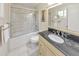 Bright bathroom with shower/tub combo, black granite vanity, and tile flooring at 951 Woodmont Dr, Marietta, GA 30062