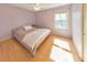 Cozy bedroom with hardwood floors, a ceiling fan, a large window, and neutral color scheme at 951 Woodmont Dr, Marietta, GA 30062