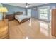 Bright bedroom with hardwood floors, large windows, a ceiling fan, and classic wooden furniture at 951 Woodmont Dr, Marietta, GA 30062