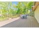 Spacious wooden deck with a dining set and lush greenery providing a private and serene outdoor space at 951 Woodmont Dr, Marietta, GA 30062