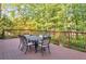 Outdoor wooden deck featuring a dining table with seating for six, perfect for gatherings at 951 Woodmont Dr, Marietta, GA 30062