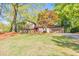 Charming home with a well-manicured lawn, mature trees, and a welcoming driveway leading to a two-car garage at 951 Woodmont Dr, Marietta, GA 30062