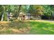 Charming multi-level home featuring a lush lawn, mature trees, and a welcoming two-car garage at 951 Woodmont Dr, Marietta, GA 30062