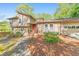 Two-story exterior featuring stone accents, mature landscaping, attached garage, and a charming front porch at 951 Woodmont Dr, Marietta, GA 30062