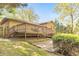 Rear exterior view showcasing a multi-level deck, patio, and lush backyard with mature trees, perfect for outdoor living at 951 Woodmont Dr, Marietta, GA 30062