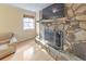 Living room showcasing a stone fireplace, hardwood floors, and natural light at 951 Woodmont Dr, Marietta, GA 30062