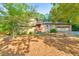 Front exterior showcasing a red front door, two car garage, stone details, and green foliage at 951 Woodmont Dr, Marietta, GA 30062