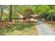 Charming home with a well-manicured lawn, mature trees, and a two-car garage at 951 Woodmont Dr, Marietta, GA 30062