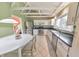 Bright kitchen featuring white cabinetry, stainless steel appliances, and tile floors at 951 Woodmont Dr, Marietta, GA 30062