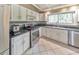 Modern kitchen boasts stainless steel appliances, light cabinetry, and light-colored tile floors at 951 Woodmont Dr, Marietta, GA 30062