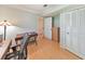 An office space with a wooden desk, chair, and white closet, illuminated by a unique lamp at 951 Woodmont Dr, Marietta, GA 30062