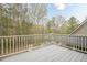 A back deck offers an outdoor space with views of the surrounding trees at 18 Crolley Ln, White, GA 30184