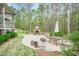 Scenic backyard patio with stone fireplace, comfortable seating, and lush greenery at 18 Crolley Ln, White, GA 30184
