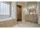 A luxurious primary bathroom with a separate shower, soaking tub, and double vanity at 18 Crolley Ln, White, GA 30184