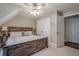 A neutral-toned bedroom with a wooden bed frame features an overhead fan and closet at 18 Crolley Ln, White, GA 30184