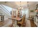 Open dining room with coffered ceilings, hardwood floors, chandelier, staircase, and backyard views at 18 Crolley Ln, White, GA 30184
