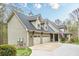This angle of the home features a large three car garage, flag pole and a covered porch at 18 Crolley Ln, White, GA 30184