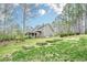 Sprawling backyard with green grass and wooded surroundings at 18 Crolley Ln, White, GA 30184