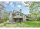 Back of house featuring a wall of windows and a long patio with a stone foundation at 18 Crolley Ln, White, GA 30184