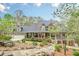 Charming home featuring a landscaped front yard, covered porch, dormer windows, and a three-car garage at 18 Crolley Ln, White, GA 30184