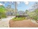 Home with three-car garage, covered porch, dormer windows, stone accents and landscaped front yard at 18 Crolley Ln, White, GA 30184
