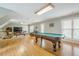 An expansive game room boasts natural light, a pool table, TV, and sitting area at 18 Crolley Ln, White, GA 30184