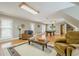 A spacious game room with natural light features a pool table, comfortable armchairs, and a large rug at 18 Crolley Ln, White, GA 30184