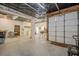 A large garage space perfect for storage or a workshop, including shelving units, and a rollup garage door at 18 Crolley Ln, White, GA 30184