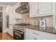 Close up of kitchen with stainless steel gas range and custom range hood at 18 Crolley Ln, White, GA 30184