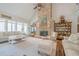 Bright living room with soaring ceilings, stone fireplace, and large windows offering serene views at 18 Crolley Ln, White, GA 30184