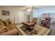 A cozy living room features hardwood floors, area rug, brown sofa, and a ceiling fan at 18 Crolley Ln, White, GA 30184