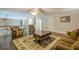 A view from a living room with hardwood floors, area rug, brown sofa, and a ceiling fan at 18 Crolley Ln, White, GA 30184