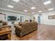 A well-lit room featuring hardwood floors, coffered ceilings, a large TV, and a comfortable sitting area at 18 Crolley Ln, White, GA 30184