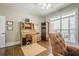 Bright office features a wooden rolltop desk, chair, and natural light from the large window at 18 Crolley Ln, White, GA 30184