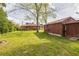 Lush backyard with utility building, offering space for recreation and potential expansion at 5295 Woodland Dr, Lake City, GA 30260