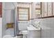 Cozy bathroom featuring a shower with a seat, patterned wallpaper, and a vanity at 5295 Woodland Dr, Lake City, GA 30260
