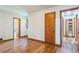 Bedroom featuring gleaming hardwood floors, wood doors, and ample natural light at 5295 Woodland Dr, Lake City, GA 30260