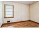 Bedroom featuring wallpaper, hardwood floors, and a window with blinds at 5295 Woodland Dr, Lake City, GA 30260